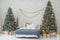 New Year bedroom interior. Bed with blue bedspread stands between two Christmas trees decorated with balls and tinsel