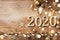 New Year celebration and festive background with golden numbers 2020, confetti stars and Christmas decorations top view