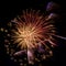 New Year celebration firework in red, golden and blue on black background