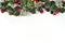 New Year or Christmas background with garland from frosty pine branches, cones, red balls