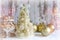 New Year, Christmas background, rustic style. Festive Christmas tree in gold on white wood background and craft boxes tied with sa