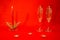 New Year and Christmas card on a red background. Two glasses of champagne and a candle. Minimalism concept. Content for the