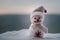 New Year Christmas concept. The snowman stands on snow with blurred nature background. White snowman surrounded by Christmas trees