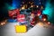 New year or Christmas holiday shopping concept. Store promotions. Santa Claus carrying trolley cart on snow. Stack of gift boxes