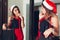 New Year or Christmas party preparation. Woman choosing skirt for outfit wearing Santa`s hat and tinsel by mirror