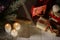 The New Year composition of the glowing candles, wrapped gifts and part of the Christmas tree placed on the old wooden