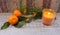 New Year composition with tangerines, arborvitae branch, candles and Christmas trees