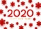 New Year concept - 2020 numbers on white background with paper snowflakes for winter holidays design