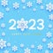 New Year concept - 2023 numbers on blue background with paper snowflakes for winter holidays design