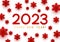 New Year concept - 2023 numbers on white background with paper snowflakes for winter holidays design