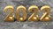 New year concept. Golden number 2022 on marble background