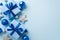 New Year concept. Top view photo of big gift boxes with ribbon bows blue and silver baubles sparkle star ornaments and snowflake