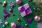 New Year concept. Top view photo of lilac giftbox with violet ribbon bow pink purple baubles reindeer ice skates flower snowflake