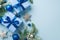 New Year concept. Top view photo of present boxes with bows blue and silver baubles star ornaments spruce branches in snow and