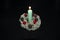 New Year decoration with a candle made of lichen, cones and berries