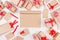 New Year festive mock up - blank kraft paper sketchbook surrounded gifts with red bows on white wooden background.
