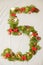 New year figure five. on a plain background. spruce branches decorated with Christmas decorations