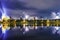 New Year fireworks over a city, night view to the illuminated sky. Streaks of light  upon the lake. Gniezno