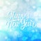 New Year greeting card with hand lettering holiday greetings Happy New Year and snowflakes on blue bokeh background.