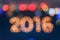 New year greeting card made of bokeh digits in shape of 2016