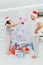 New year guy and girl decorate Christmas tree. Winter holiday and celebration. Couple in love in santa hat, family. Xmas