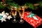 New Year holiday concept. New Year\\`s decor - champagne glasses, a gift, New Year\\`s toys, a Christmas tree with decorations