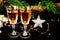 New Year holiday concept. New Year\\\'s decor - champagne glasses, a gift, New Year\\\'s toys, a Christmas tree with decorations. Clos