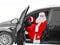 New Year holiday. Santa Claus - the driver sits behind the wheel of the car with a bag of gifts.