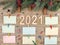 New year horizontal business background.Decorated pine paws lie on a wooden background.Numbers 2021,note sheets, and other office
