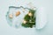 New Year layout big hole paper background mint color. Christmas toys glasses goblets blue background. Christmas concept