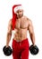 New year man with muscular body in red and white christmas santa hat standing on studio with white background