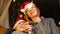 New Year mood concept. Mom and son in Christmas hats smile and look at the burning sparkler