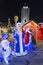 New year night scene. Christmas figures of Santa Claus and snowman on the background of night