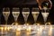 New year party, pouring of brut champagne bubbles cava or prosecco wine in tulip glasses with garland lights on background