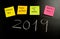 New Year resolutions or popular Goals and colorful sticky post its notes on chalk blackboard