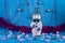 New Year`s adventures of cheerful snowmen on a blue stage