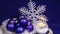 New Year`s balls on a dark blue background with snowflake