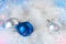 New Year`s blue and silver balls on white fluff