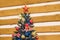 New Year\\\'s Christmas holiday green tree decorated toys balloons ribbons on wooden background