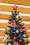 New Year\\\'s Christmas holiday green tree decorated toys balloons ribbons on wooden background, close up