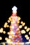 New Year's Christmas tree decorated with luminous multi-colored garlands
