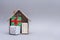 New Year`s composition. Wooden house with gifts on a gray background