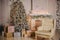 New Year`s decor, an armchair, beautifully packaged gifts, a Christmas tree with a Christmas toys and a fireplace