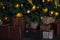 New Year`s decor. Christmas tree, New Year, with brown and yellow balls. Brown and beige boxes with gifts are under the tree