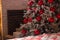 New Year`s decor. Christmas tree, New Year, with red balls and white decor. white boxes with gifts in stripes. snow and frost on