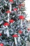 New Year`s decoration, vertical. Artificial eco spruce and decorations in the fly agaric. Beautiful Christmas tree with