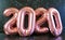 New Year`s Eve 2020 number metallic balloons on black marble background table.