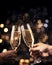 New year\\\'s eve celebration: Toasting happiness with champagne flutes in hand. With copyspace
