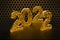 New Year\\\'s Eve hive with bee on honey comb Shiny hexagonal gold number 2021 on a black background with bees