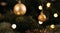 New Year\\\'s golden colored toys and garland hang on a natural Christmas tree. Close-up and soft focus